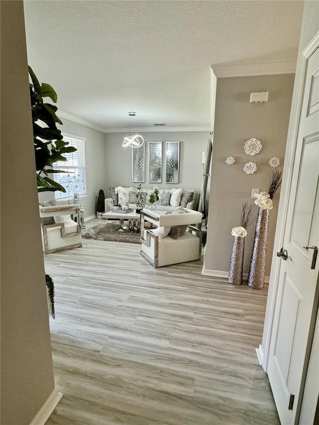 1016 Cascade Dr, Davenport, FL 33837 - living room with crown molding, light wood finished floors, a textured ceiling, and a chandelier