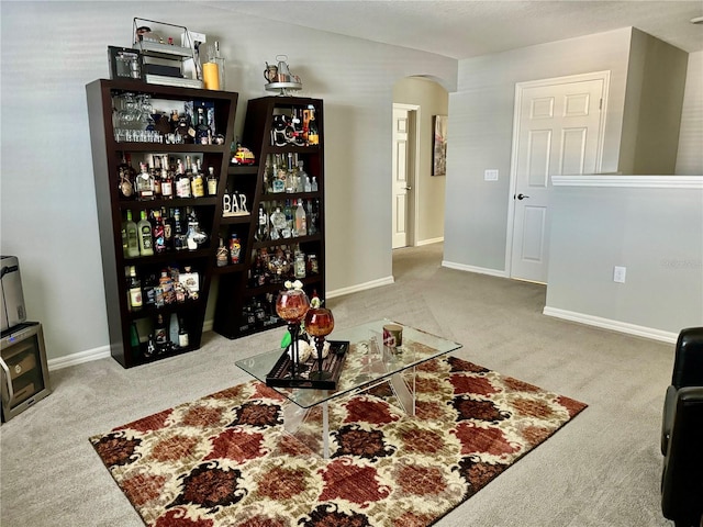 1016 Cascade Dr, Davenport, FL 33837 - carpeted living area featuring arched walkways and baseboards