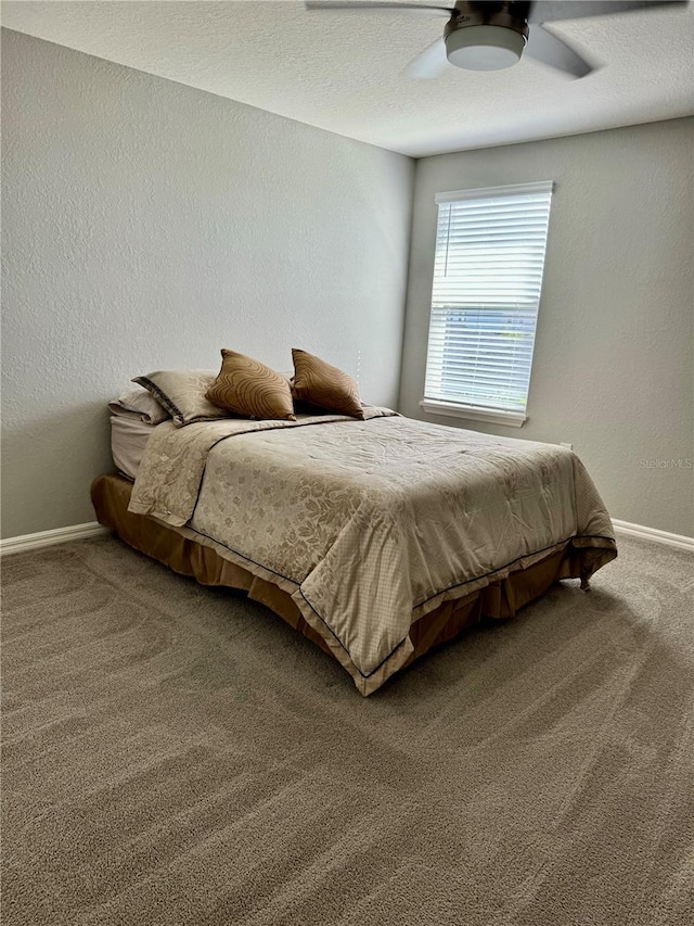 1016 Cascade Dr, Davenport, FL 33837 - bedroom with carpet floors, a textured wall, and a ceiling fan