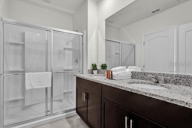 7622 Oakmoss Loop, Davenport, FL 33837 - bathroom with a shower stall, double vanity, and tile patterned flooring