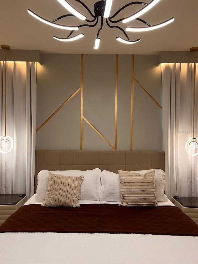 7622 Oakmoss Loop, Davenport, FL 33837 - bedroom featuring a chandelier