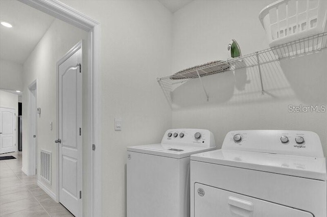 7622 Oakmoss Loop, Davenport, FL 33837 - laundry room featuring washer and dryer and light tile patterned floors