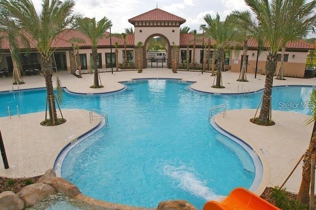 7622 Oakmoss Loop, Davenport, FL 33837 - community pool featuring a patio area