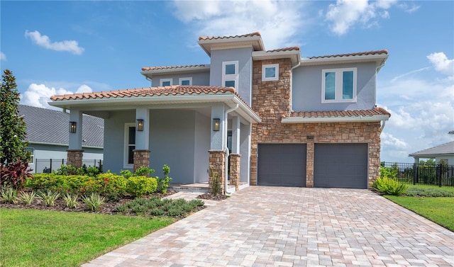 15600 Vetta Dr, Bella Collina, FL 34756 - mediterranean / spanish house featuring stone siding, stucco siding, an attached garage, decorative driveway, and a tile roof