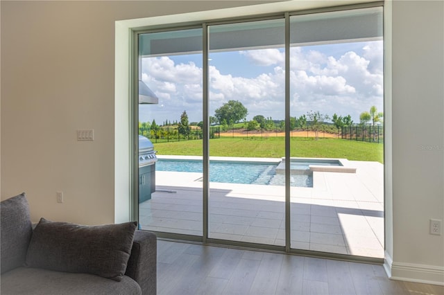 15600 Vetta Dr, Bella Collina, FL 34756 - doorway featuring wood finished floors and baseboards