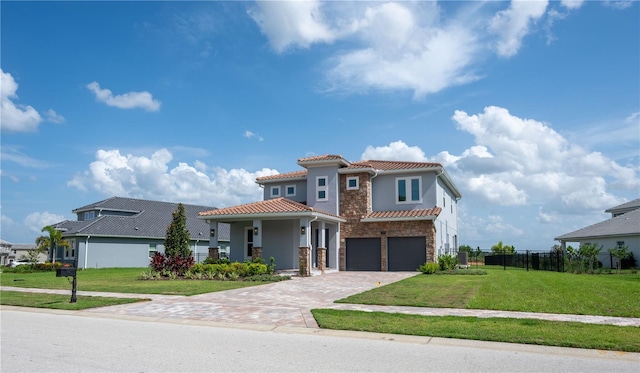 15600 Vetta Dr, Bella Collina, FL 34756 - mediterranean / spanish-style house with stone siding, a tile roof, a garage, driveway, and stucco siding