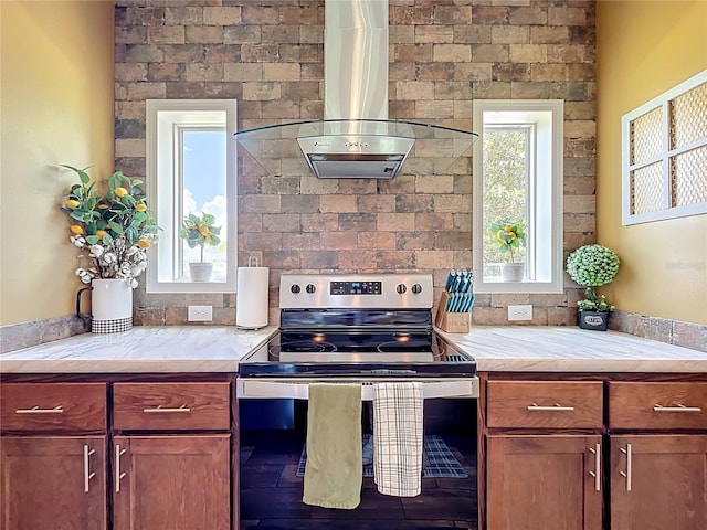 15311 Johns Lake Rd, Clermont, FL 34711 - kitchen with stainless steel electric range oven, wall chimney range hood, wood finished floors, and light stone counters