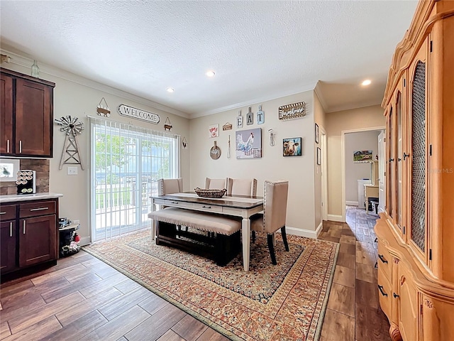 15311 Johns Lake Rd, Clermont, FL 34711 - dining room with wood finished floors, crown molding, a textured ceiling, recessed lighting, and baseboards