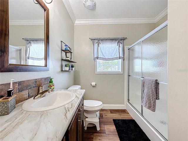 15311 Johns Lake Rd, Clermont, FL 34711 - bathroom featuring crown molding, toilet, vanity, a stall shower, and wood finished floors