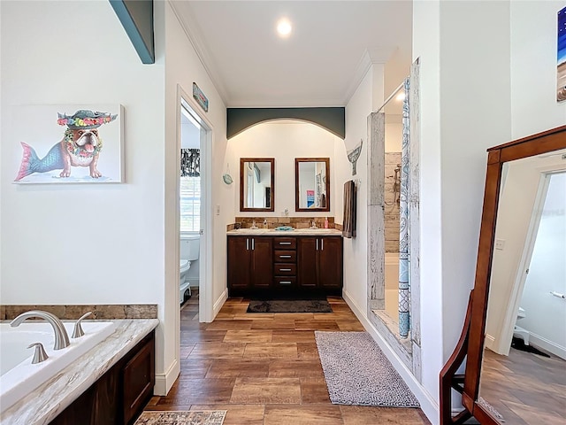 15311 Johns Lake Rd, Clermont, FL 34711 - full bath featuring toilet, a garden tub, double vanity, wood finished floors, and a shower