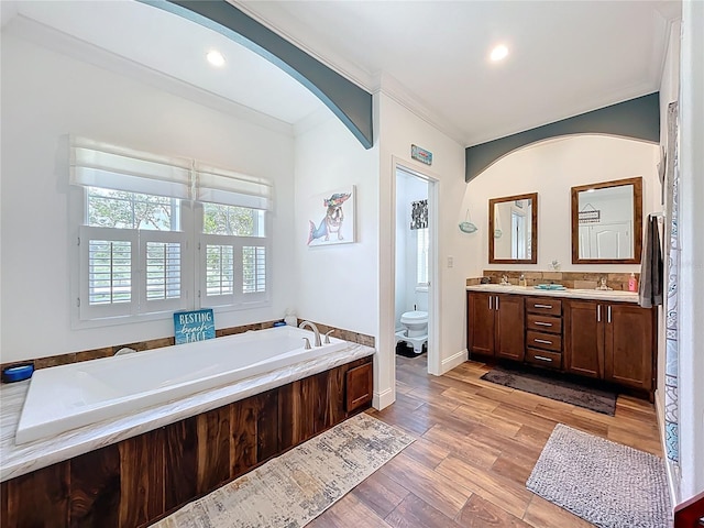 15311 Johns Lake Rd, Clermont, FL 34711 - full bath featuring toilet, a garden tub, double vanity, wood finished floors, and recessed lighting