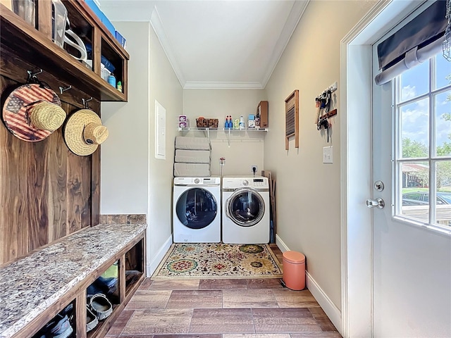 15311 Johns Lake Rd, Clermont, FL 34711 - laundry area featuring ornamental molding, washing machine and dryer, plenty of natural light, baseboards, and wood finished floors