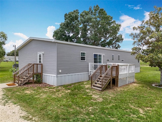 15311 Johns Lake Rd, Clermont, FL 34711 - back of property featuring a lawn and a deck
