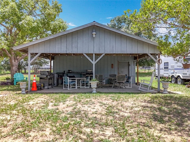 15311 Johns Lake Rd, Clermont, FL 34711 - rear view of property with a patio area and a detached carport