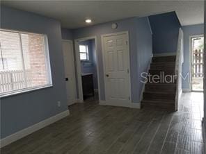 5144 Picadilly Circus Ct Unit 2, Orlando, FL 32839 - interior space with baseboards, plenty of natural light, dark wood-type flooring, stairway, and recessed lighting