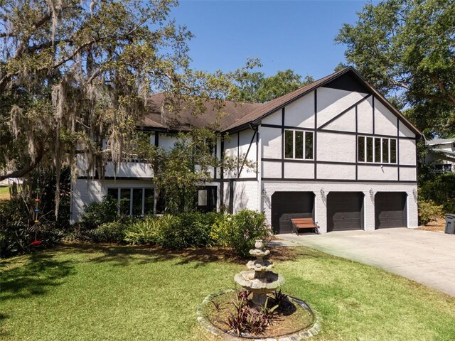 11951 Elbert St, Clermont, FL 34711 - view of front of house featuring stucco siding, concrete driveway, a garage, and a front yard