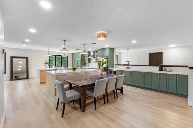 11951 Elbert St, Clermont, FL 34711 - dining space with light wood finished floors, recessed lighting, and a textured ceiling
