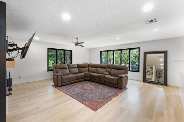 11951 Elbert St, Clermont, FL 34711 - living room featuring a textured ceiling, recessed lighting, light wood-type flooring, healthy amount of natural light, and ceiling fan