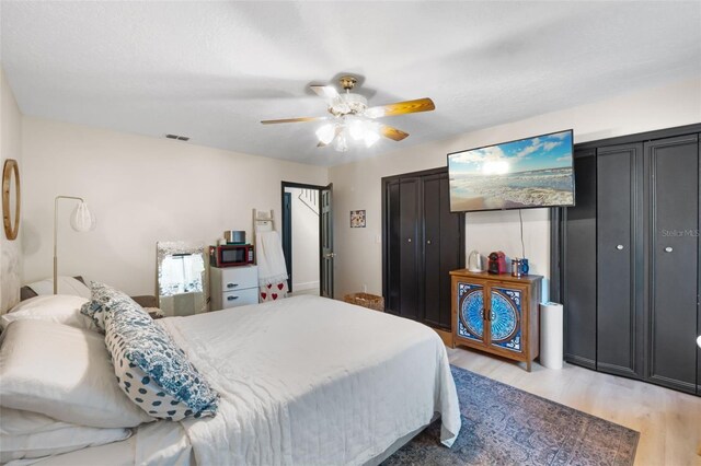 11951 Elbert St, Clermont, FL 34711 - bedroom with light wood finished floors and a ceiling fan