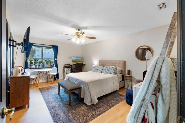 11951 Elbert St, Clermont, FL 34711 - bedroom with wood finished floors, ceiling fan, and a textured ceiling