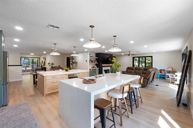 11951 Elbert St, Clermont, FL 34711 - kitchen with a spacious island, open floor plan, plenty of natural light, light brown cabinetry, and recessed lighting