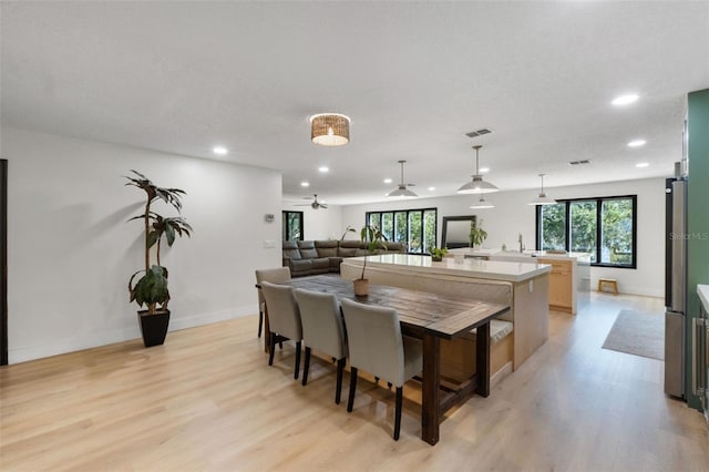 11951 Elbert St, Clermont, FL 34711 - kitchen with recessed lighting, open floor plan, light wood finished floors, light countertops, and hanging light fixtures