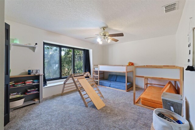 11951 Elbert St, Clermont, FL 34711 - carpeted bedroom with a textured ceiling and ceiling fan