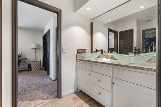 11951 Elbert St, Clermont, FL 34711 - bathroom with double vanity and wood finished floors