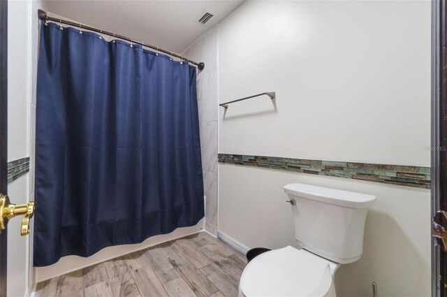 11951 Elbert St, Clermont, FL 34711 - bathroom with wood finished floors and shower / bath combination with curtain