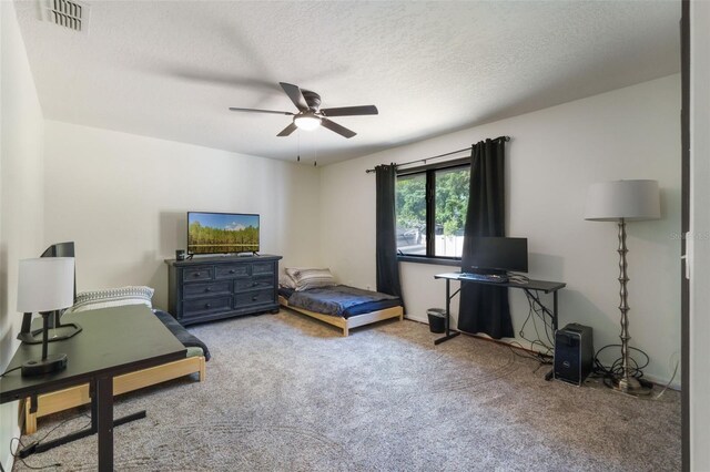 11951 Elbert St, Clermont, FL 34711 - carpeted bedroom featuring ceiling fan and a textured ceiling