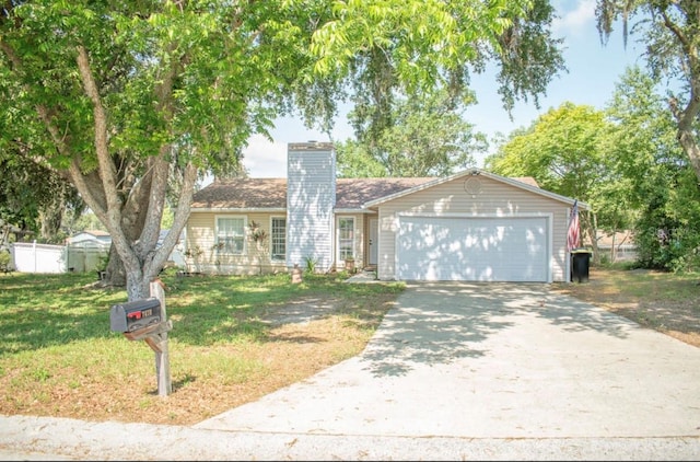 7410 Orange Crest Cir, Lakeland, FL 33810 - single story home with driveway, a chimney, and an attached garage