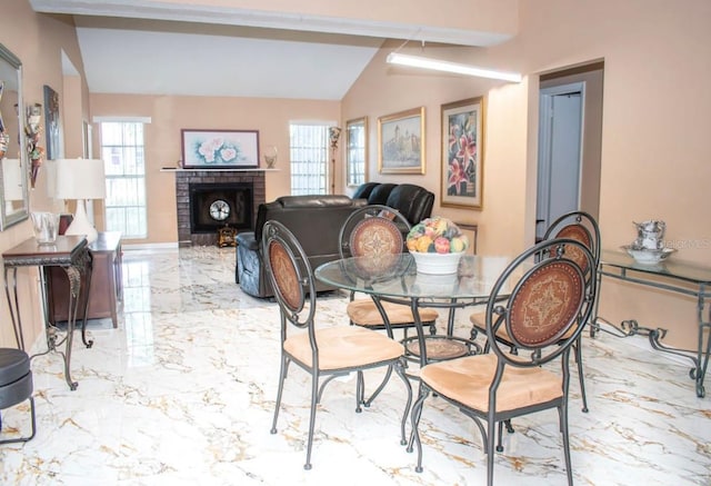 7410 Orange Crest Cir, Lakeland, FL 33810 - dining room with marble tiled flooring, plenty of natural light, a fireplace, and vaulted ceiling