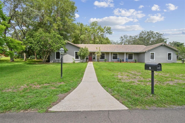 16 Pine Forest Dr, Haines City, FL 33844 - ranch-style home with a front lawn and stucco siding