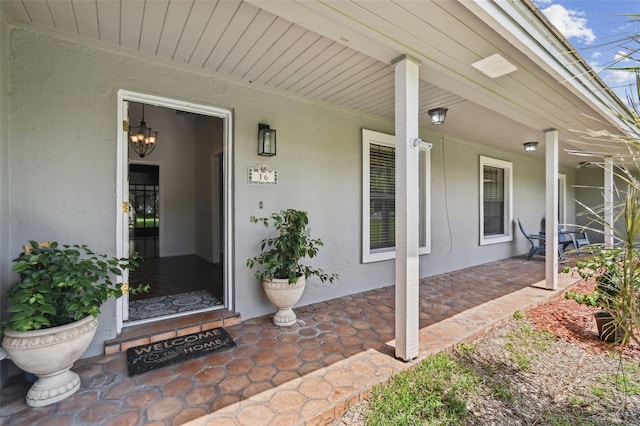 16 Pine Forest Dr, Haines City, FL 33844 - view of exterior entry with stucco siding and covered porch