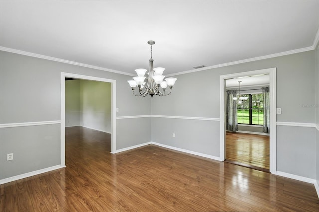 16 Pine Forest Dr, Haines City, FL 33844 - unfurnished room with a chandelier, wood finished floors, and crown molding