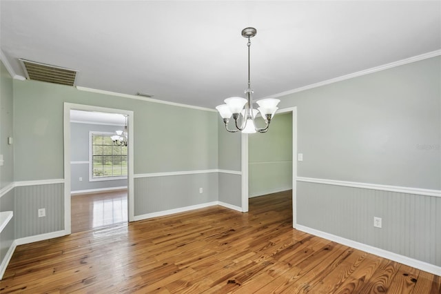 16 Pine Forest Dr, Haines City, FL 33844 - spare room with a chandelier, wood-type flooring, and crown molding