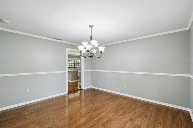 16 Pine Forest Dr, Haines City, FL 33844 - empty room with a chandelier, ornamental molding, wood finished floors, and a smoke detector