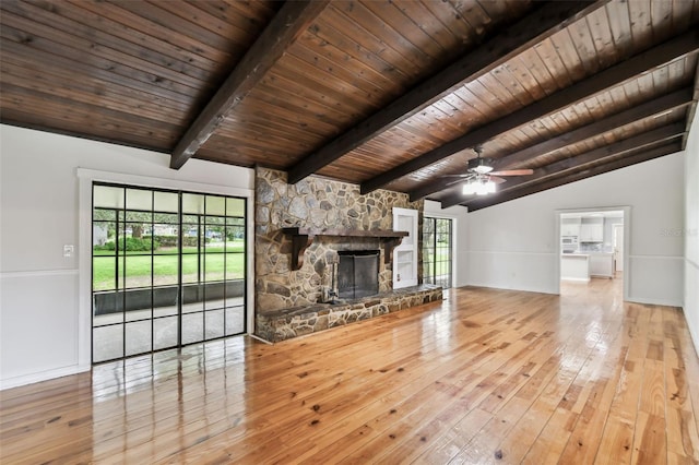 16 Pine Forest Dr, Haines City, FL 33844 - unfurnished living room with hardwood / wood-style flooring, wooden ceiling, a stone fireplace, and ceiling fan