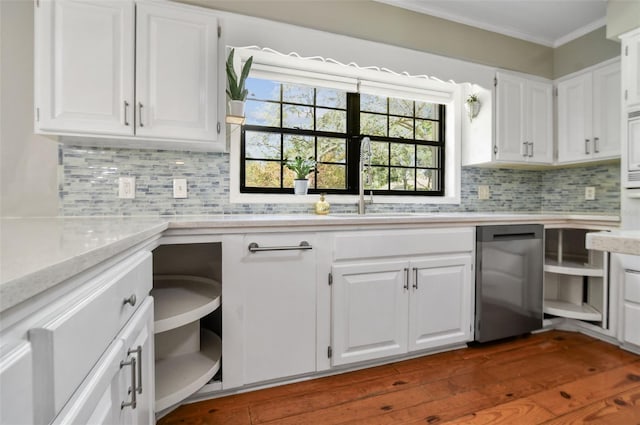 16 Pine Forest Dr, Haines City, FL 33844 - kitchen featuring crown molding, stainless steel dishwasher, white cabinets, backsplash, and dark wood-type flooring