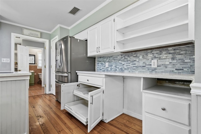 16 Pine Forest Dr, Haines City, FL 33844 - kitchen with open shelves, white cabinetry, ornamental molding, light countertops, and hardwood / wood-style flooring
