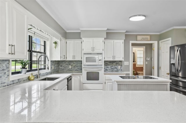 16 Pine Forest Dr, Haines City, FL 33844 - kitchen featuring stainless steel appliances, decorative backsplash, white cabinetry, ornamental molding, and light stone counters