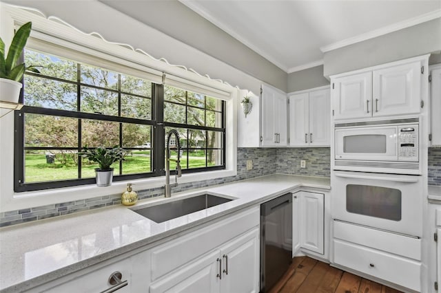16 Pine Forest Dr, Haines City, FL 33844 - kitchen featuring white appliances, crown molding, white cabinetry, backsplash, and light stone counters