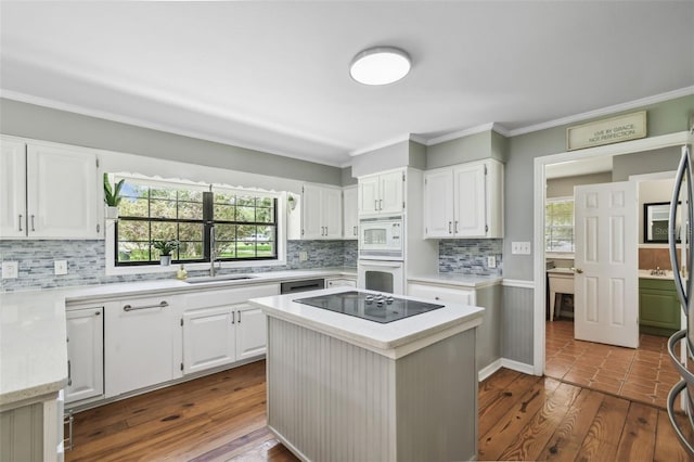 16 Pine Forest Dr, Haines City, FL 33844 - kitchen featuring white appliances, ornamental molding, tasteful backsplash, and white cabinetry