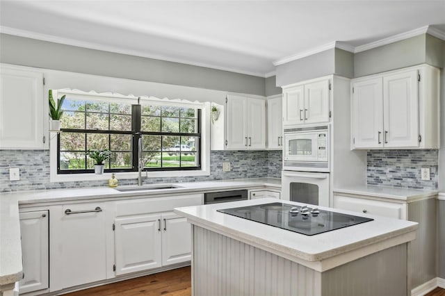 16 Pine Forest Dr, Haines City, FL 33844 - kitchen with white appliances, light countertops, white cabinets, and ornamental molding