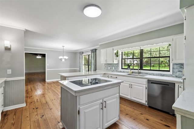 16 Pine Forest Dr, Haines City, FL 33844 - kitchen with dishwasher, ornamental molding, a chandelier, wainscoting, and black electric stovetop