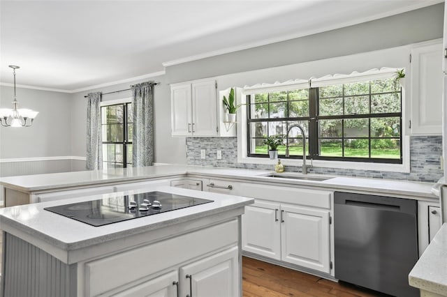 16 Pine Forest Dr, Haines City, FL 33844 - kitchen featuring dishwasher, black electric cooktop, crown molding, a peninsula, and tasteful backsplash