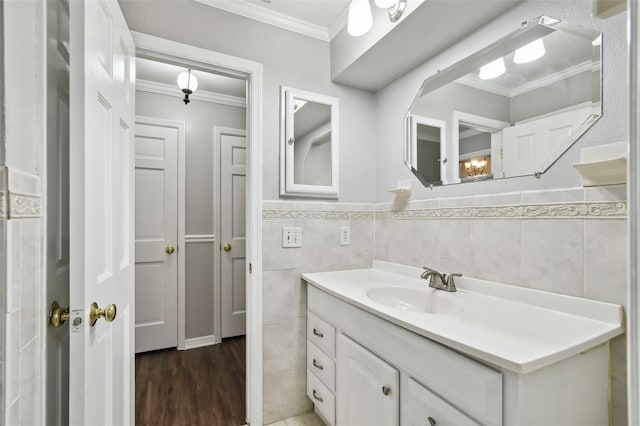 16 Pine Forest Dr, Haines City, FL 33844 - bathroom featuring vanity, tile walls, ornamental molding, wood finished floors, and wainscoting