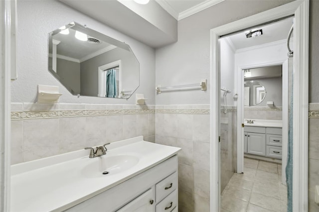 16 Pine Forest Dr, Haines City, FL 33844 - bathroom with crown molding, tile walls, vanity, a wainscoted wall, and tile patterned flooring