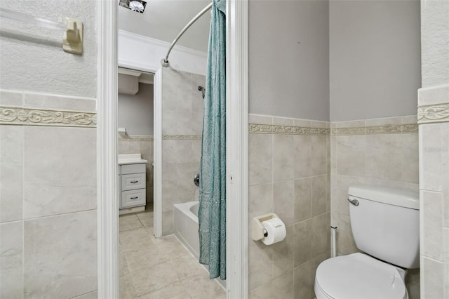 16 Pine Forest Dr, Haines City, FL 33844 - bathroom with tile walls, shower / bath combo with shower curtain, tile patterned floors, crown molding, and a wainscoted wall