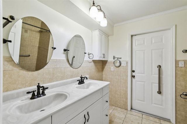 16 Pine Forest Dr, Haines City, FL 33844 - bathroom with tile walls, double vanity, tile patterned flooring, wainscoting, and ornamental molding